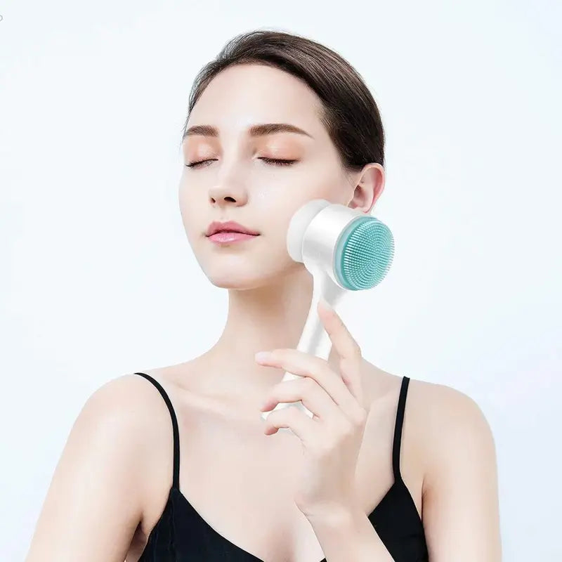 New Magna SilkCleanse Pro 2-in-1 Silicone Face Brush - Woman applying silicone cleansing brush to cheek with eyes closed, gentle facial massage and deep pore cleansing skincare routine