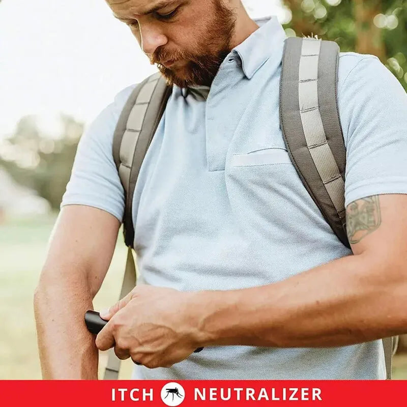 Man with a backpack using an itch Neutralizer device outdoors