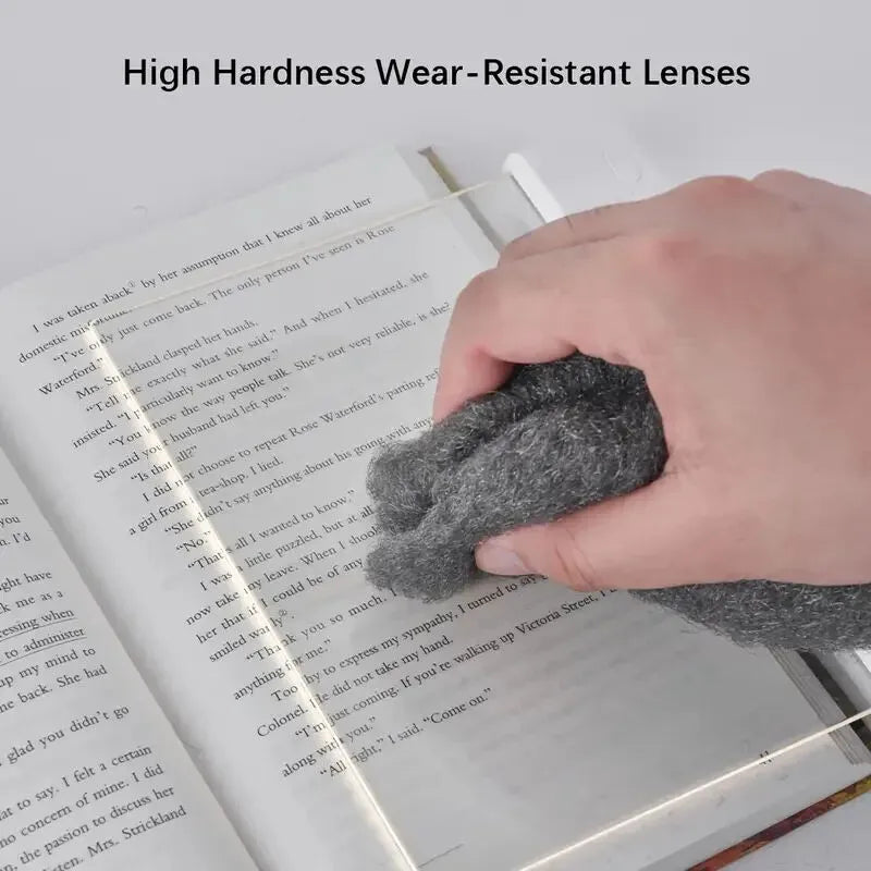 Hand using a gray cloth to clean a book with text, emphasizing high hardness wear-resistant lenses.