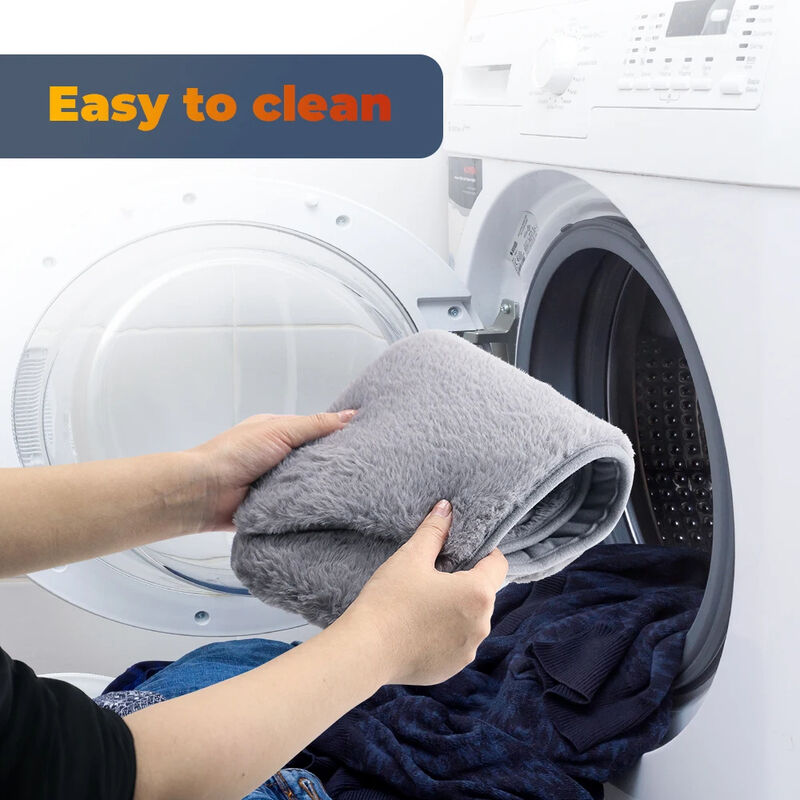 Person holding a gray towel in front of an open washing machine with 'Easy to clean' text above.